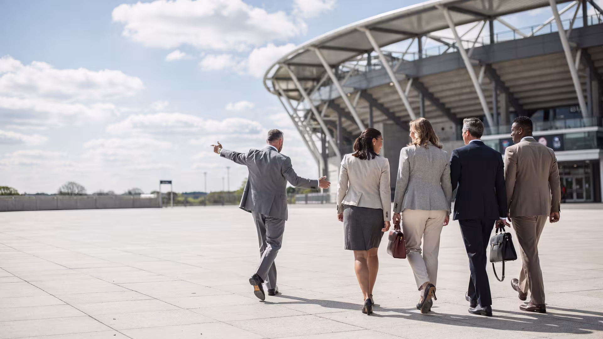 Corporate guests arriving at a modern rugby stadium