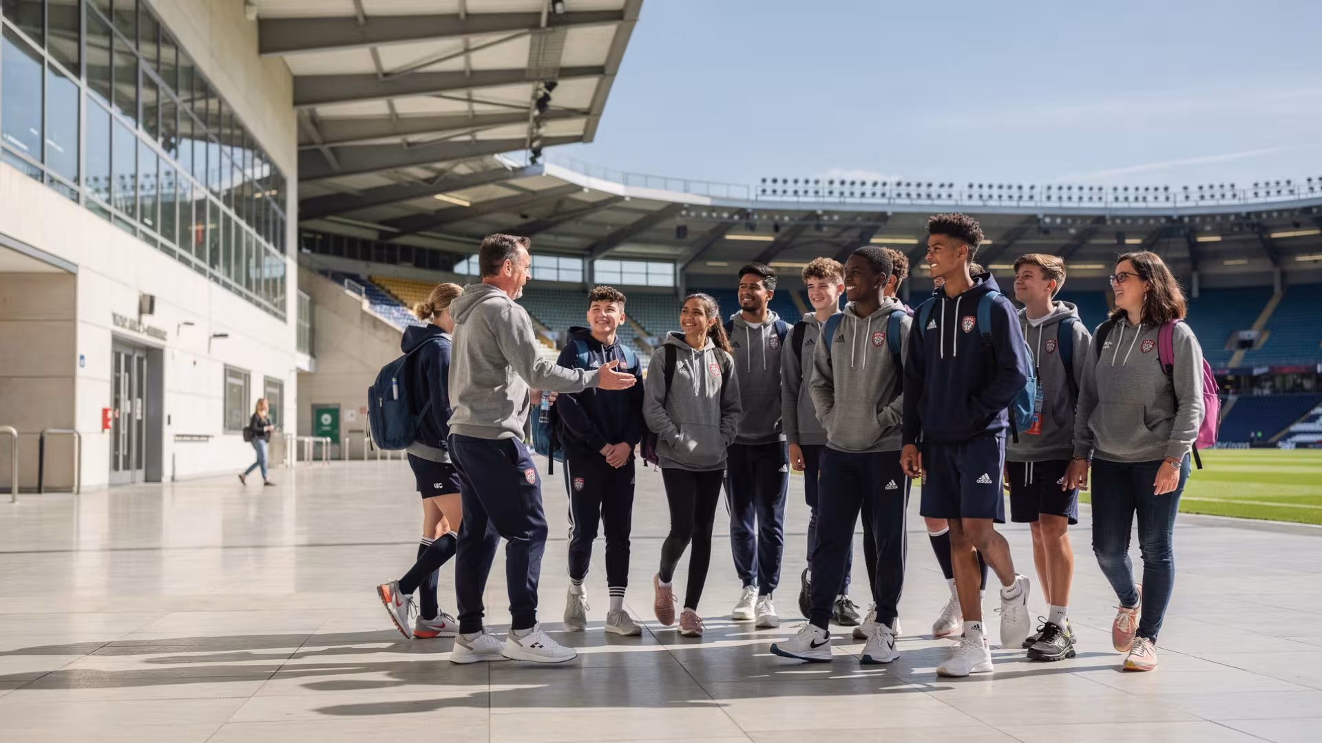 Youth rugby team taking a guided stadium venue tour