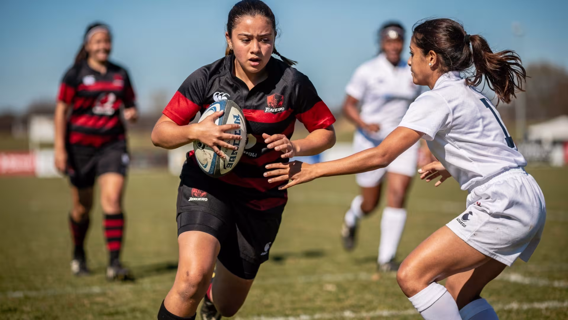 A 15-year-old girls rugby player running with the ball looking directly at the camera