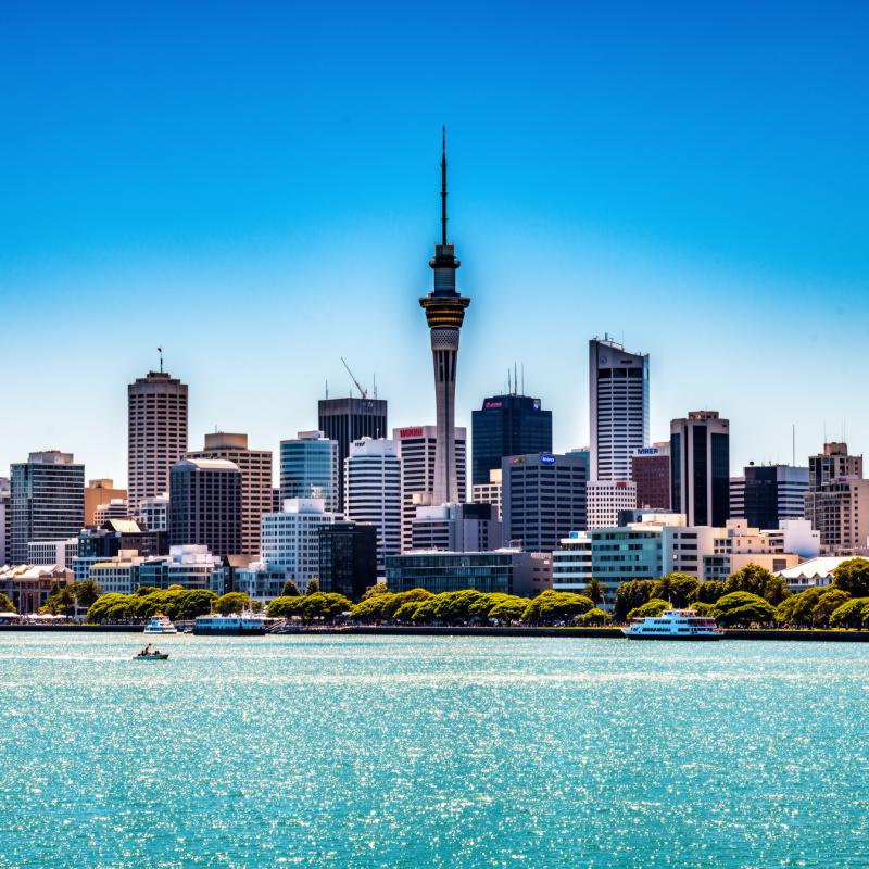 The Auckland skyline with the Sky Tower, New Zealand, under bright blue sky